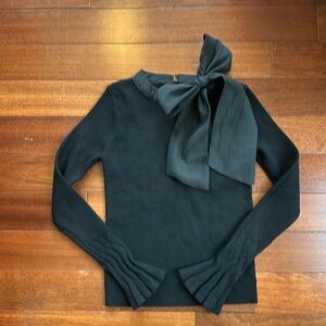 Black sweater with bow detailing at neck